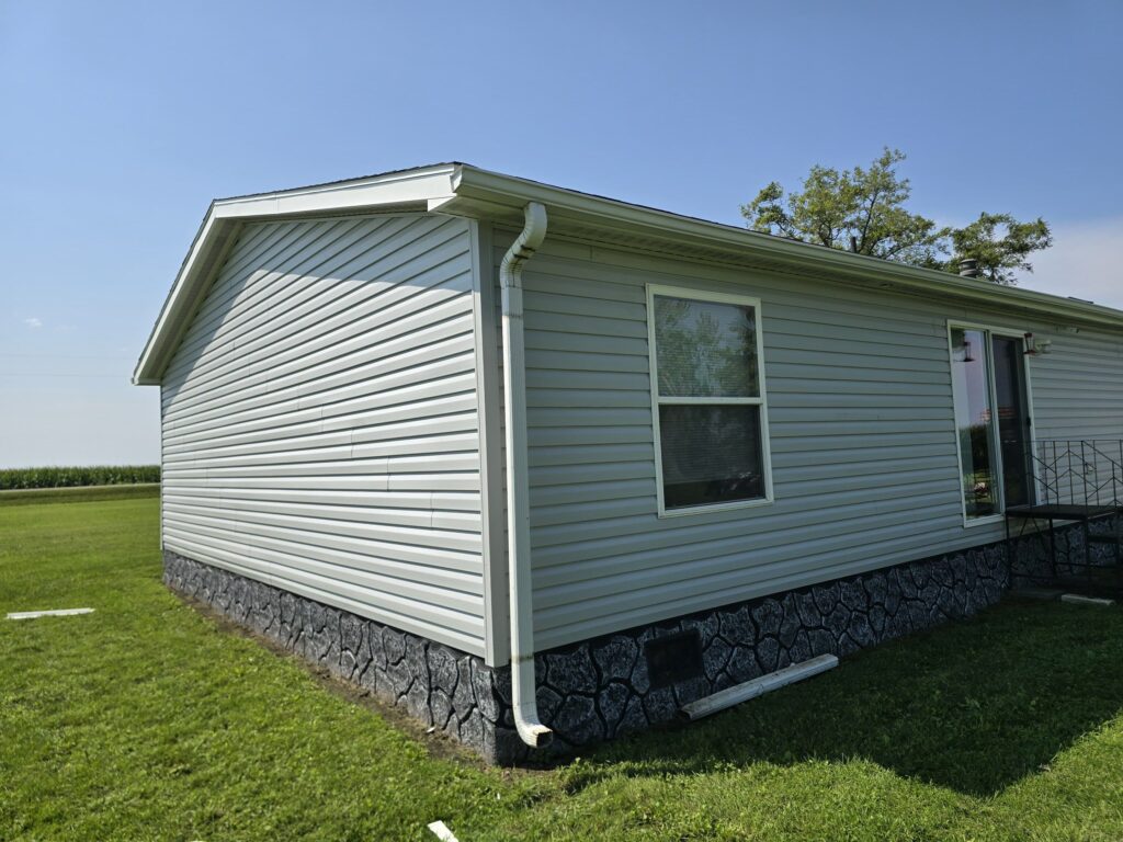 New vinyl siding, white gutters and downspout on a Villisca, IA home