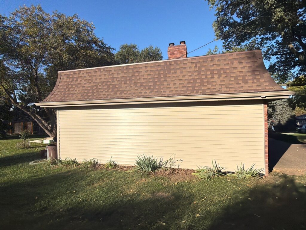 Gable end with new Dutch lap vinyl siding and new shingle roof in Omaha, NE 68144