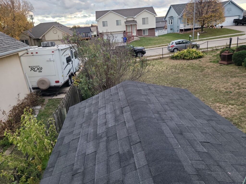New black architectural shingle roof in a Papillion, NE neighborhood